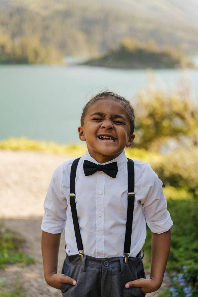 Aiden gives a very cheesy smile with his hands in his pockets.