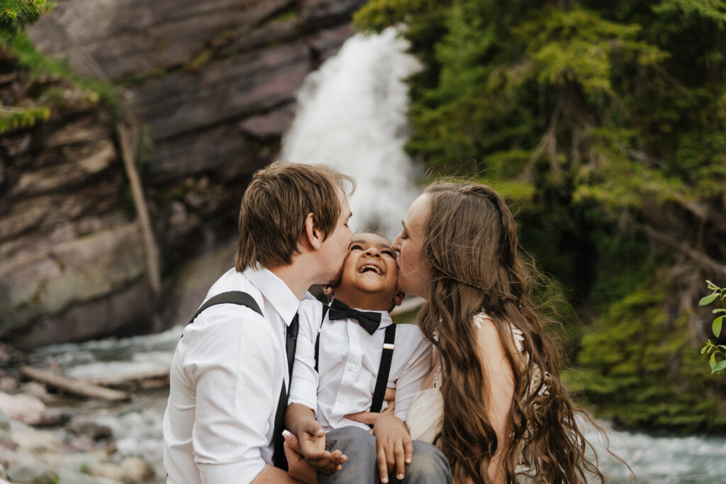 Bree and Will kiss Aiden's cheeks at the Baring Falls.
