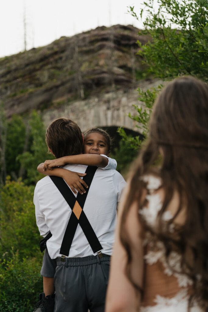 Aiden is getting carried by Will as they hike back from the Baring Falls.