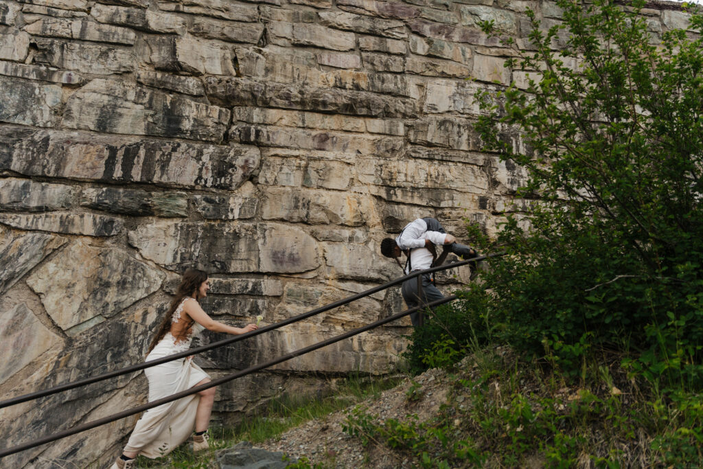 Aiden is carried over Will's shoulder as the family climbs the steps out of the Baring Falls.