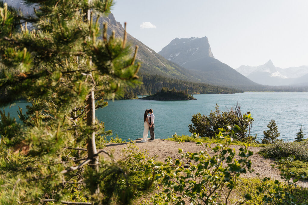 Bride and groom looking out at the lake at Sun Point in Glacier National Park.