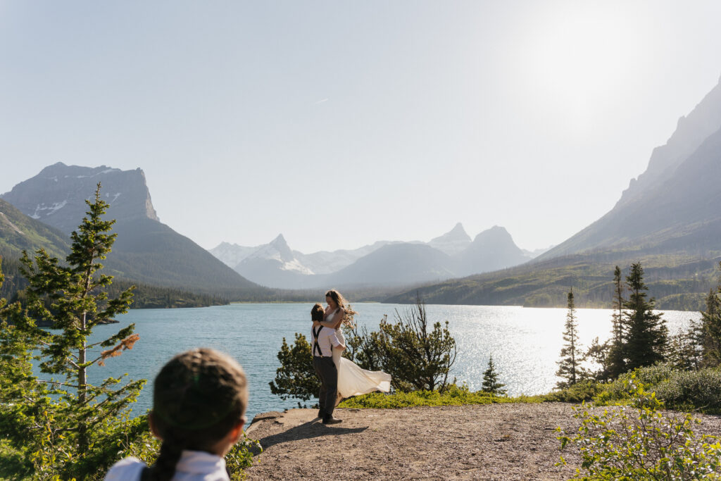 Bride and groom's child shows photographer where to shoot during elopement in Glacier National Park.