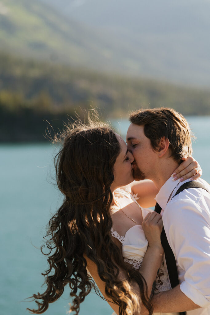 Bride and groom kiss after eloping in Sun Point Glacier National Park.