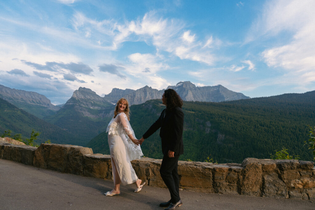 Couple walks on Going to the Sun Road in Glacier National Park after eloping.