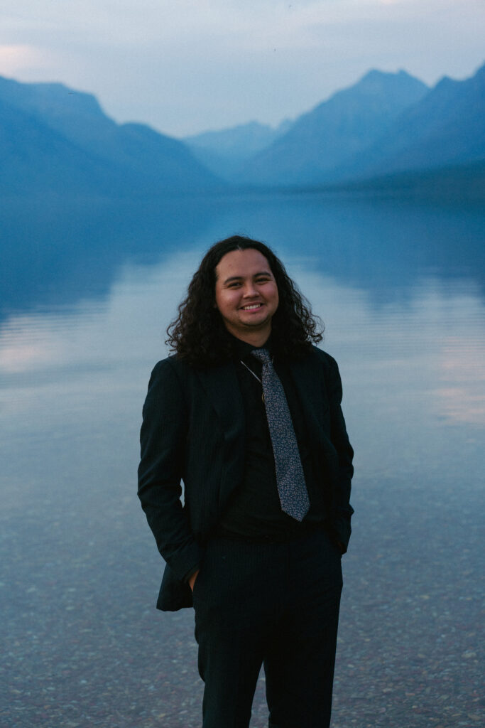 Broom poses in Lake McDonald after elopement in Glacier National Park.
